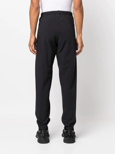 Shop Veilance Elasticated-waist Tapered Trousers In Black