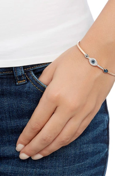 Swarovski Rose Gold-tone Clear And Blue Crystal Evil Eye Adjustable Bangle Bracelet In Rose Gold