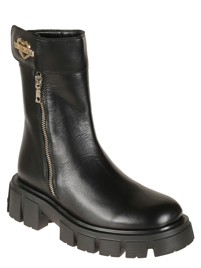 Shop Love Moschino Metal Heart Plaque Side Zipped Boots In Black