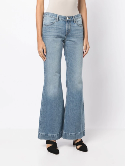 Shop Re/done 70s Low-rise Flared Jeans In Blue