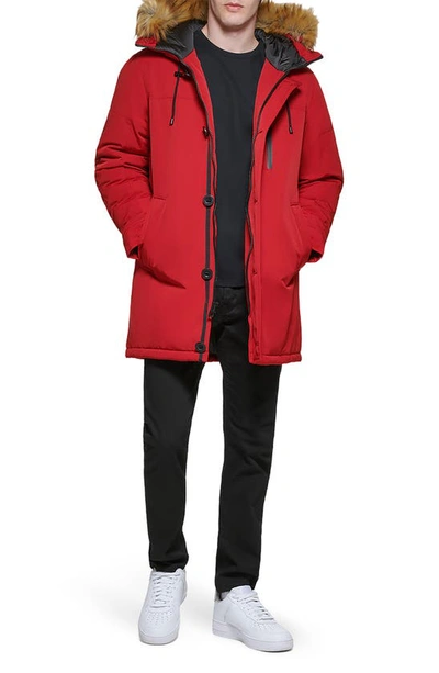 Shop Guess Faux Fur Trim Hooded Parka Jacket In Red