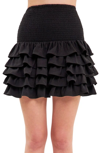 Shop Endless Rose Smocked Tiered Ruffle Miniskirt In Jet Black