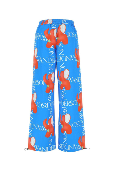 Shop Jw Anderson Graphic Printed Wide Leg Trousers In Blue