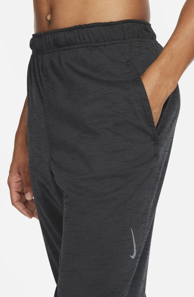 Shop Nike Pocket Yoga Pants In Off Noir/ Black/ Gray