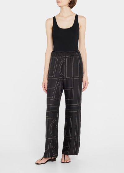 Shop Totême Monogram Silk Pajama Pants In Black