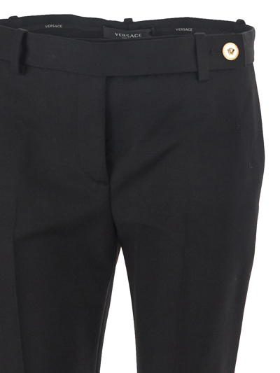 Shop Versace Flared Pants In Black