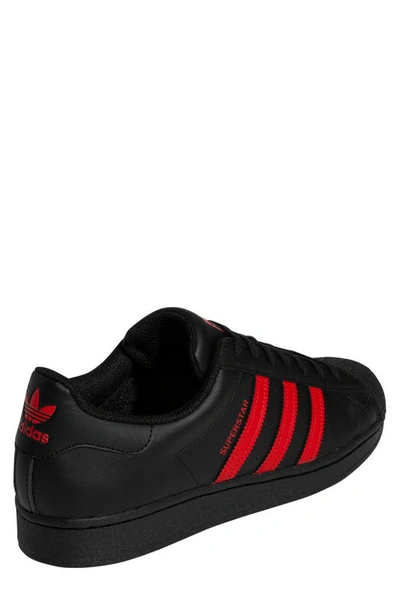 Shop Adidas Originals Superstar Sneaker In Black/ Red