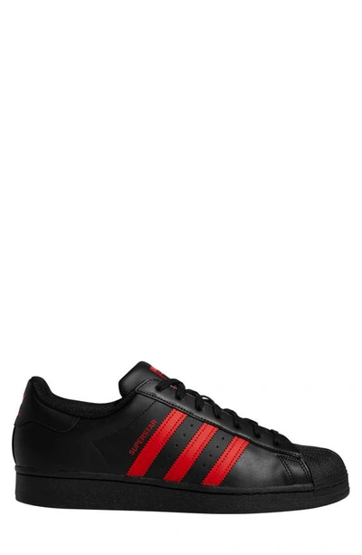 Shop Adidas Originals Superstar Sneaker In Black/ Red