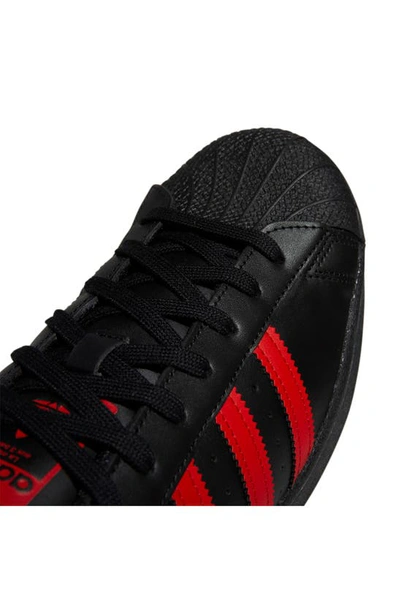 Shop Adidas Originals Superstar Sneaker In Black/ Red