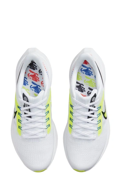 Shop Nike Kids' Air Zoom Pegasus 39 Sneaker In White/ Volt/ Racer Blue/ Black
