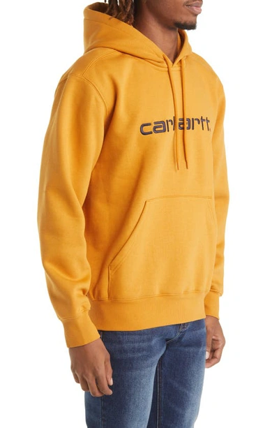 Shop Carhartt Hooded Logo Sweatshirt In Ochre / Dark Navy