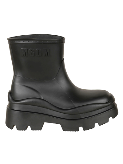 Shop Msgm Logo Embossed Rain Boots In Black