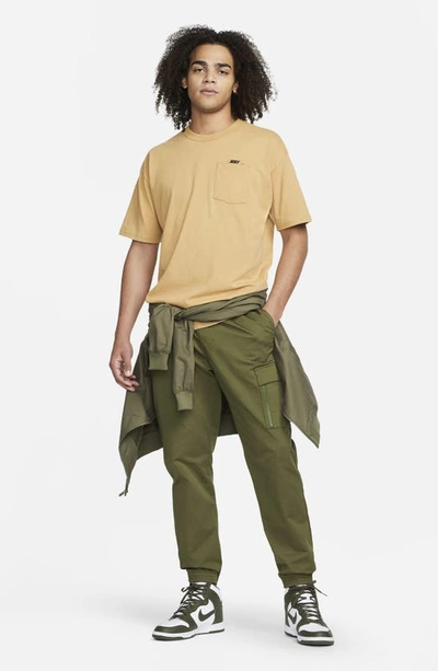 Shop Nike Sportswear Premium Essentials Pocket T-shirt In Elemental Gold