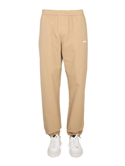 Shop Msgm Pants With Logo In Beige