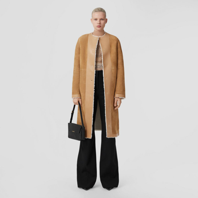 Shop Burberry Reversible Shearling Collarless Coat In Wheat
