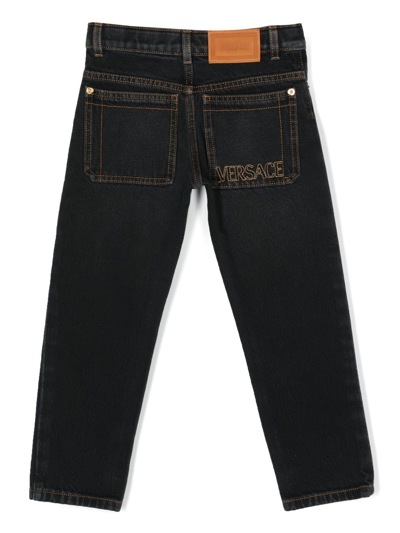 Shop Versace Embroidered-logo Detail Jeans In Black
