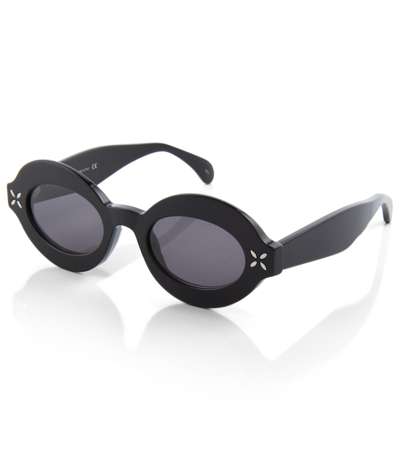 Shop Alaïa Oval Sunglasses In Black-black-grey