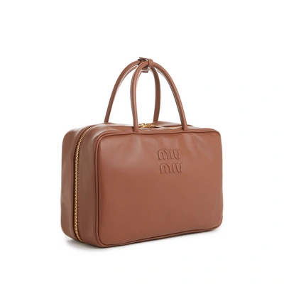 Shop Miu Miu Calfskin Leather Handbag In Brown