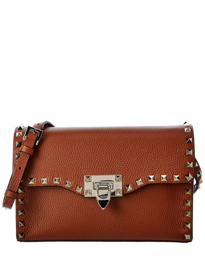 Shop Valentino Rockstud Small Grainy Leather Crossbody In Brown