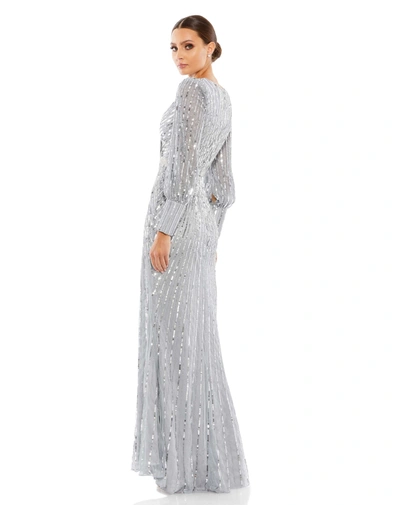Shop Mac Duggal Sequined Wrap Over Bishop Sleeve Gown In Silver