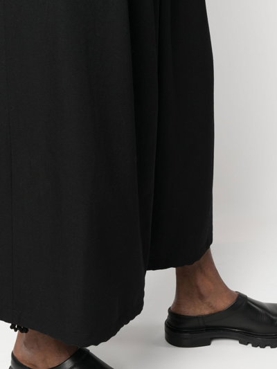 Shop Yohji Yamamoto Pleated Cropped Wide Trousers In Black