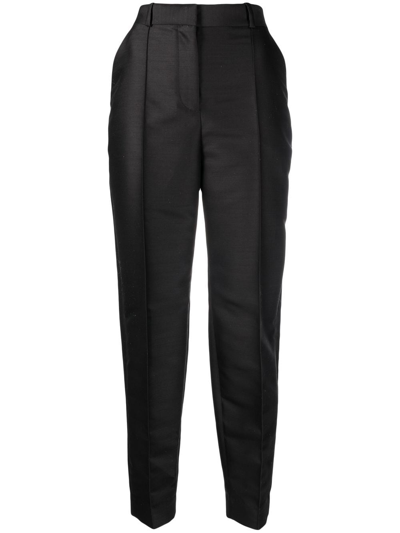 Shop Totême Pressed-crease Tapered Trousers In Black
