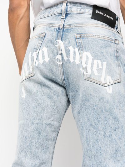 Shop Palm Angels Curved-logo Print Jeans In Blue