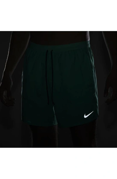 Shop Nike Dri-fit Stride 2-in-1 Running Shorts In Light Menta/ Midnight Navy