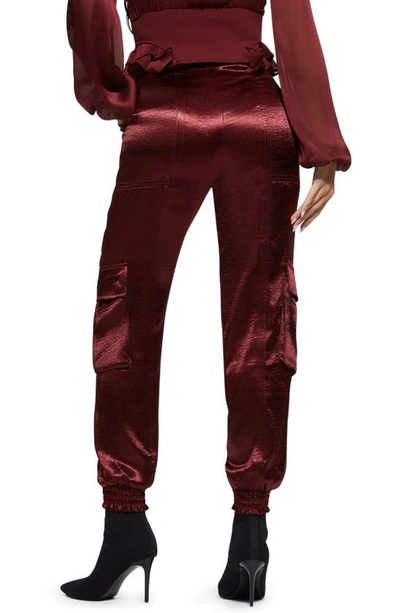 Shop Guess Soundwave Textured Satin Cargo Pants In Mystic Wine