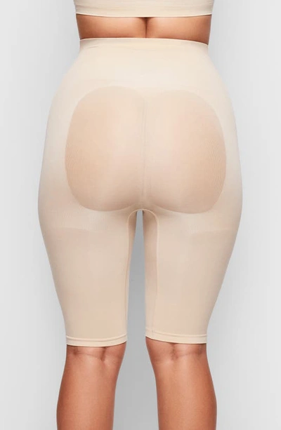 Shop Skims Sculpting Above The Knee Shorts In Clay
