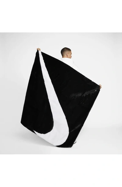 Shop Nike Swoosh Faux Fur Throw Blanket In Black/ White