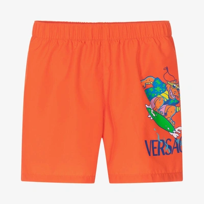 Shop Versace Boys Orange Crocodile Swim Shorts