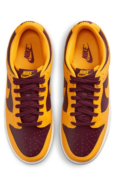 Shop Nike Dunk Low Retro Basketball Shoe In University Gold