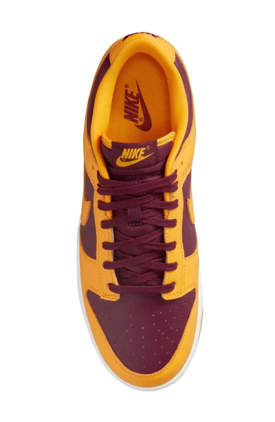 Shop Nike Dunk Low Retro Basketball Shoe In University Gold