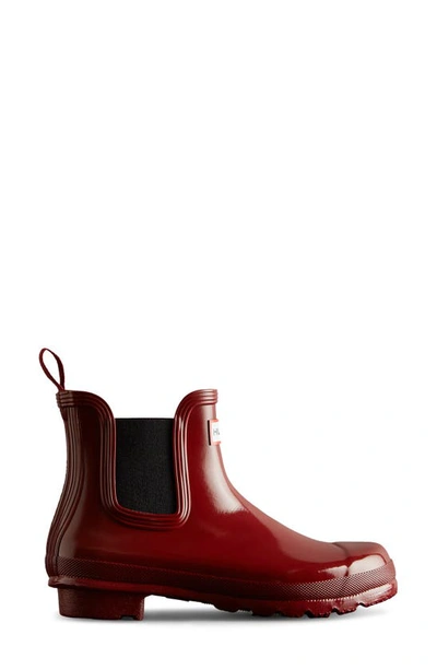 Shop Hunter Original Gloss Waterproof Chelsea Boot In Fall Red/ Black