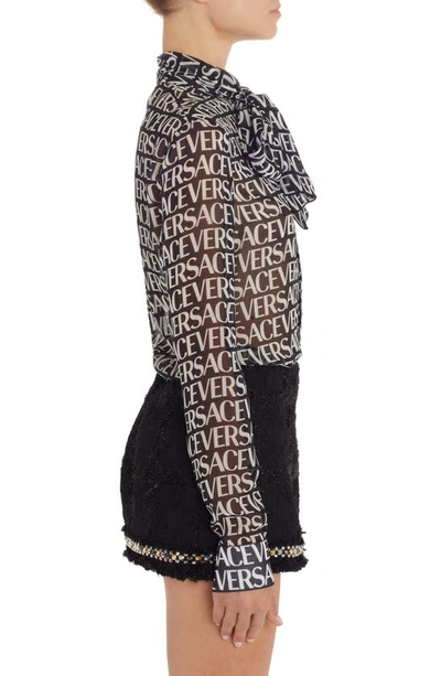Shop Versace Logo Print Semisheer Tie Neck Silk Blouse In Black/ White