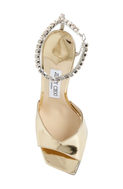 Shop Jimmy Choo Saeda Crystal Ankle Strap Peep Toe Sandal In Gold/ Crystal Honey