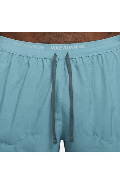 Shop Nike Dri-fit Stride 5-inch Running Shorts In Mineral Teal/ Faded Spruce