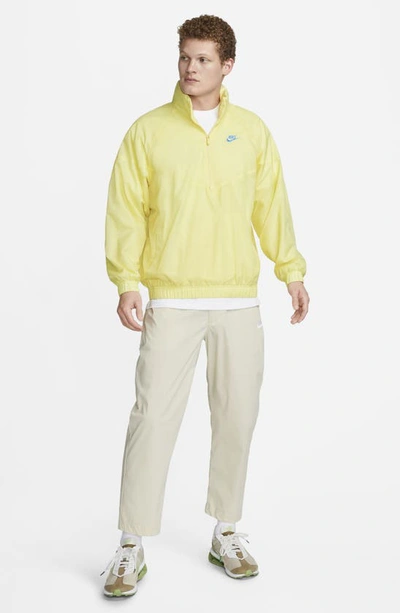 Shop Nike Water Repellent Half Zip Pullover In Lemon Chiffon/ University Blue