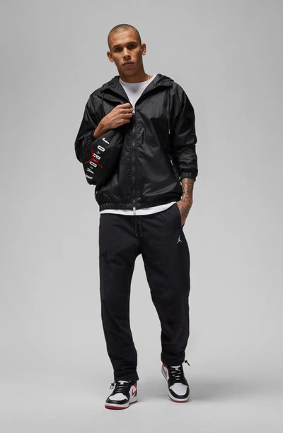 Shop Jordan Woven Stretch Nylon Pants In Black/ White