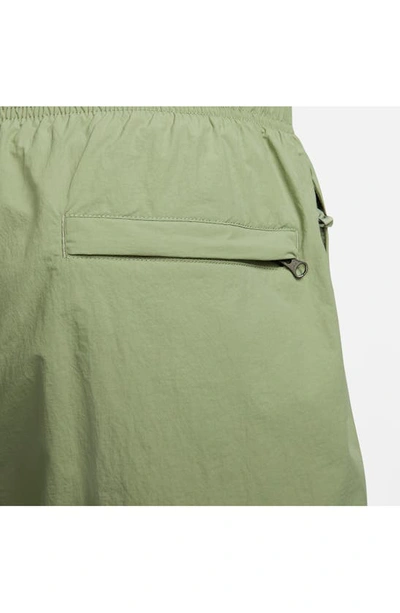 Shop Nike Solo Swoosh Water Repellent Nylon Shorts In Oil Green/ White