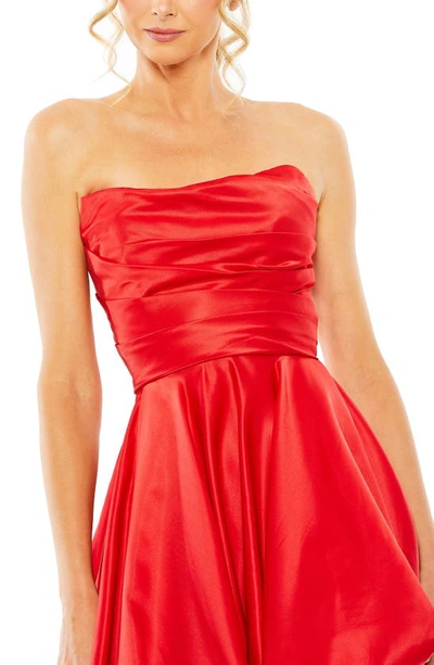 Shop Mac Duggal Strapless Asymmetric A-line Gown In Red