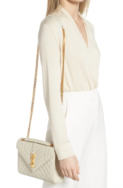 Shop Saint Laurent Medium Cassandra Quilted Leather Envelope Bag In Ivory
