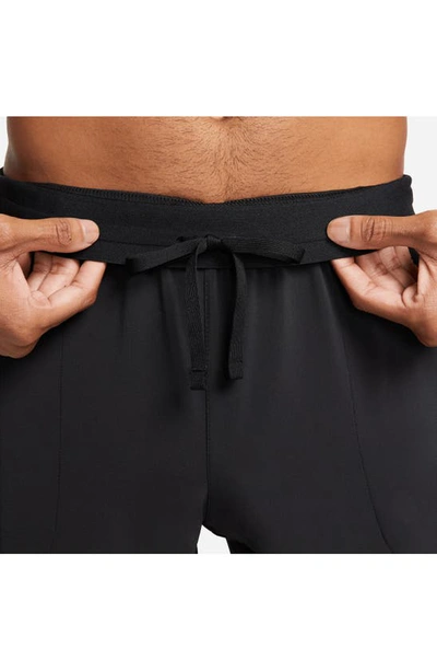 Shop Nike Flex Tapered Crop Yoga Pants In Black/ Black