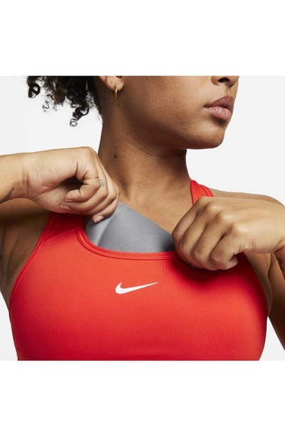 Shop Nike Swoosh Dri-fit Racerback Sports Bra In Picante Red/ White