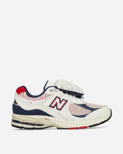 Shop New Balance 2002r Sneakers In White