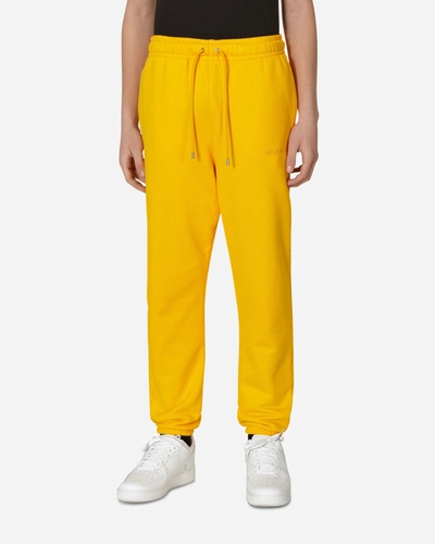 Shop Nike Wordmark Fleece Pants In Yellow