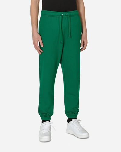 Shop Nike Wordmark Fleece Pants In Green
