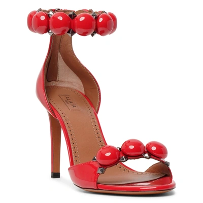Shop Alaïa La Bombe 90 Patent Red Sandals