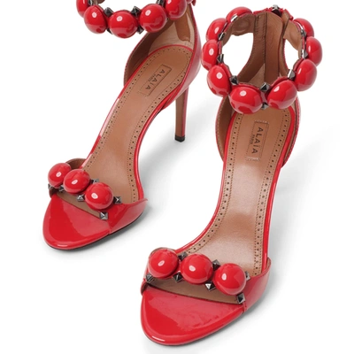 Shop Alaïa La Bombe 90 Patent Red Sandals